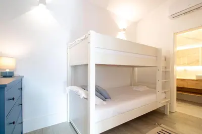 a white bunk bed in a room with a mirror at Bom Retiro's Delight by LovelyStay in Porto