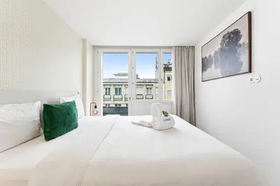 a living room with a couch and a bedroom at Urban Retreat with Balcony, Bright and Central Porto in Porto