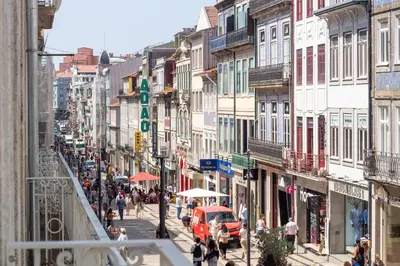 a busy city street with people and cars and buildings at Catarina 392 by LovelyStay in Porto