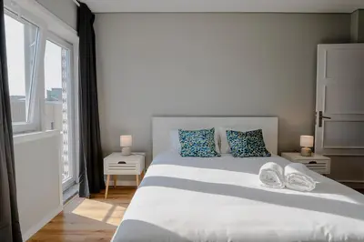 a bedroom with a large white bed and a window at 3BR Flat by Casa da Música, Central, Sleeps 6, E in Porto