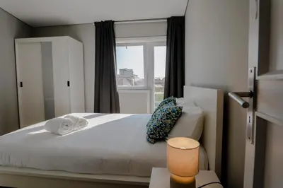 a bedroom with a large bed with a window at 3BR Flat by Casa da Música, Central, Sleeps 6, E in Porto