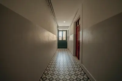 an empty hallway with a tile floor in a building at Cedofeita Loft by Hosty in Bicas