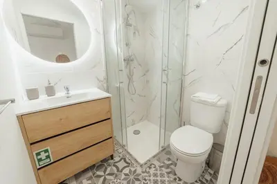 a bathroom with a shower and a toilet and a sink at Cedofeita Loft by Hosty in Bicas