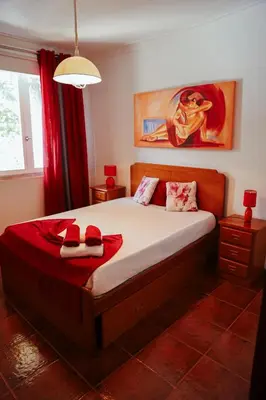 a bedroom with a bed with two slippers on it at Sailor's House 3 - Casa dos Bibos in Porto