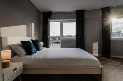 a bedroom with a large bed and a window at 3BR Flat by Casa da Música, Central, Sleeps 6, 2D in Porto