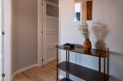 a hallway with a table and a vase with flowers on it at 3BR Flat by Casa da Música, Central, Sleeps 6, 2D in Porto