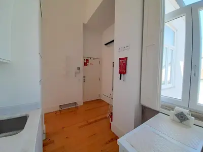 a white bathroom with a toilet and a sink at Azulejos Loft, by Flat in Porto in Porto