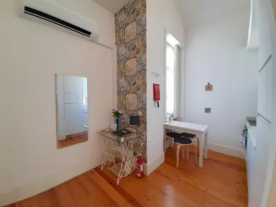 a kitchen with a wall covered in tiles at Azulejos Loft, by Flat in Porto in Porto