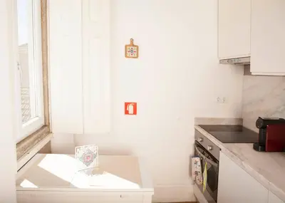 a small kitchen with a table and a counter at Azulejos Loft, by Flat in Porto in Porto