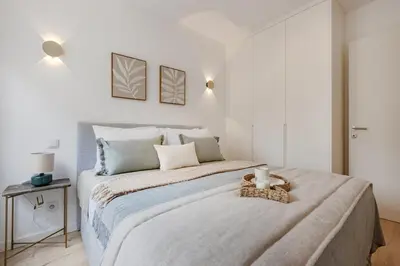 a white bedroom with a large bed in a room at The Light Loft @ BoaVista Flats in Porto