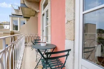 a table and chairs sitting on a balcony at Porto Cedofeita Urban Charm Residence in Porto