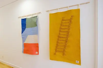 two colorful towels hanging on a wall at Porto Cedofeita Urban Charm Residence in Porto