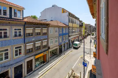 a city street with buildings and a bus at Porto Cedofeita Urban Charm Residence in Porto