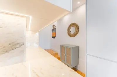 a hallway with white walls and a marble floor at Candy Crush in Porto
