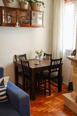 a dining room table with chairs and a blue couch at Sailor's House - Holiday's House in Porto