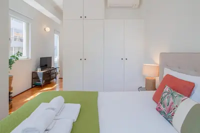 a bedroom with a bed with two towels on it at Ps70 II in Porto
