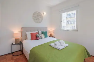 a bedroom with a bed with two towels on it at Ps70 II in Porto