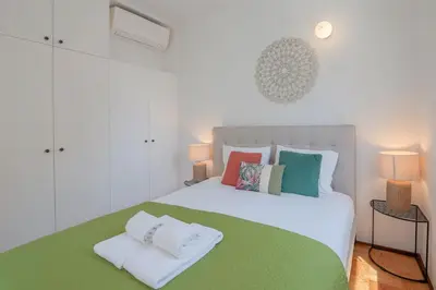 a bedroom with a white bed with towels on it at Ps70 II in Porto