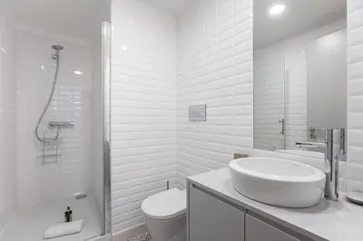 a white bathroom with a sink and a toilet at Modern Retro Downtown by LovelyStay in Porto