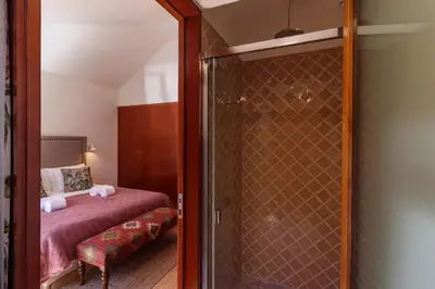 a bathroom with a glass shower with a bed at Garden of Eden - 2 bdrs, elevator, AC and terrace in Porto