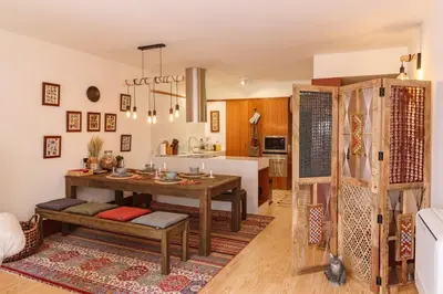 a living room with a table and a kitchen at Garden of Eden - 2 bdrs, elevator, AC and terrace in Porto