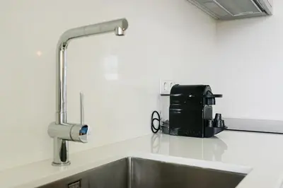 a kitchen counter with a sink and a coffee maker at GuestReady - Splendid Retreat in Porto in Porto