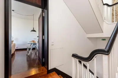 a washing machine sitting next to a door at Large Studio with City Views in Porto