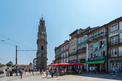 a city with a clock tower and buildings and people at Large Studio with City Views in Porto
