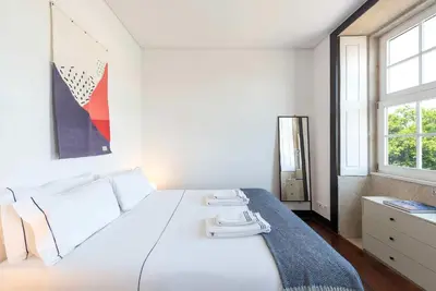 a living room with a couch and a tv at Large Studio with City Views in Porto
