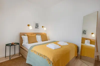 a living room with a couch and a tv at The Morning Light @ BoaVista Flats in Porto