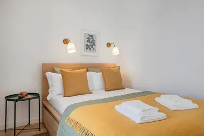 a brown couch with a picture on the wall at The Morning Light @ BoaVista Flats in Porto
