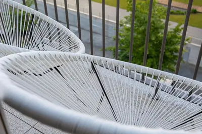 a white bench sitting on top of a balcony at GuestReady – Steps from Estádio do Dragão in Porto
