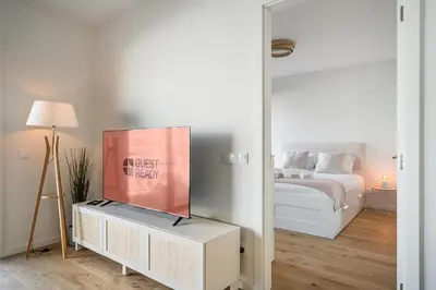 a bedroom with a bed and a mirror at GuestReady – Steps from Estádio do Dragão in Porto