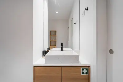 a bathroom with a white sink and a mirror at GuestReady – Steps from Estádio do Dragão in Porto