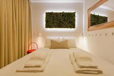 a bedroom with a bed with two towels on it at Luiz I Optimum Lofts 00 in Porto
