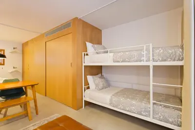 a bedroom with a white bed with towels on it at Luiz I Optimum Lofts 00 in Porto