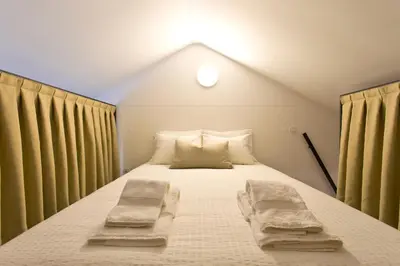 a bedroom with a bed with two pillows on it at Luiz I Optimum Lofts 01 in Porto