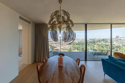 a dining room with a table and a chandelier at GuestReady - Urban luxury with Douro view in Vila Nova de Gaia