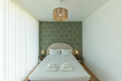 a bedroom with a bed with two towels on it at GuestReady - Urban luxury with Douro view in Vila Nova de Gaia