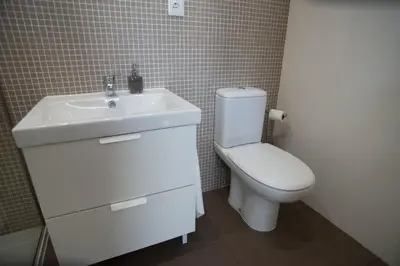 a bathroom with a white sink and a toilet at Nidos Accommodation Gaia in Vila Nova de Gaia