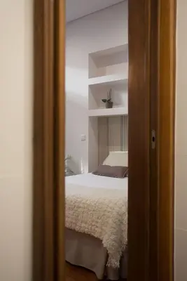 a view of a bedroom with a bed and a mirror at Nidos Accommodation Gaia in Vila Nova de Gaia