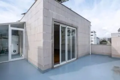 a large building with glass doors on a roof at Hostel Antas Porto in Porto