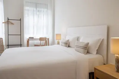 a white bedroom with a large white bed with pillows at Casa Verde by Olala Homes in Porto