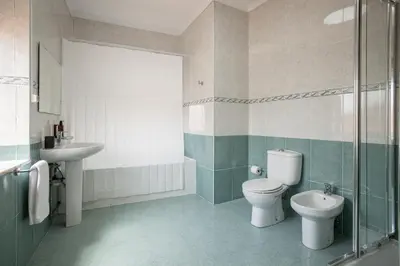 a bathroom with a toilet and a sink at Casa Verde by Olala Homes in Porto