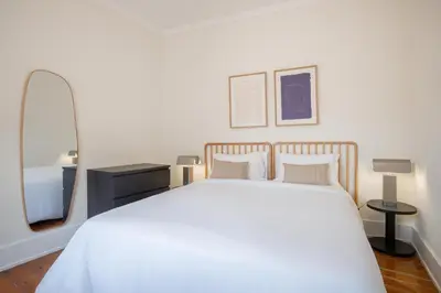 a bedroom with a white bed and a mirror at Casa Verde by Olala Homes in Porto