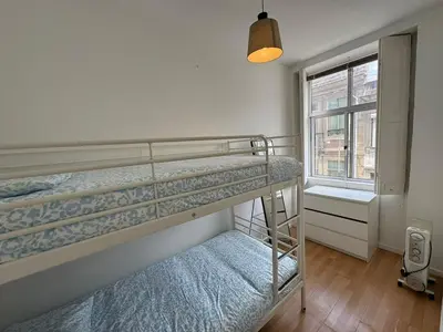 a bedroom with two bunk beds and a window at Oporto Good Vibrations -Downtown in Porto