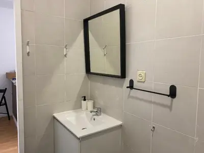 a bathroom with a sink and a mirror at Oporto Good Vibrations -Downtown in Porto