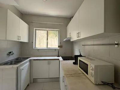 a kitchen with white cabinets and a microwave at Oporto Good Vibrations -Downtown in Porto
