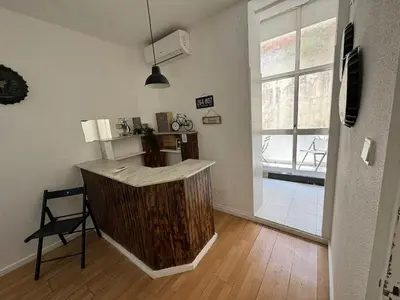 a kitchen with a counter in a room with a window at Oporto Good Vibrations -Downtown in Porto