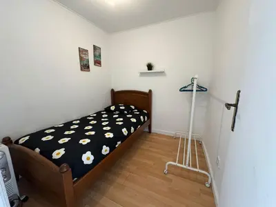 a bedroom with a bed with a black and white comforter at Oporto Perfect Days - Downtown in Porto